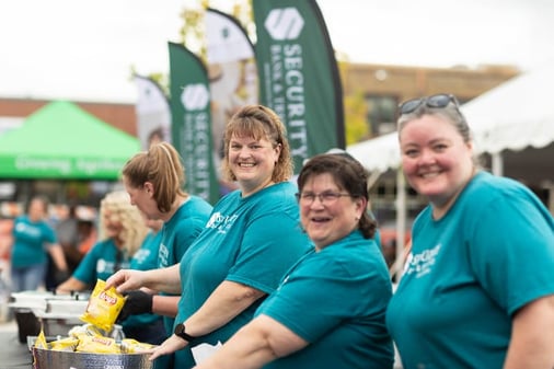 Security Bank & Trust Co. team serving food at the Glencoe Block Party in Minnesota.