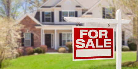 For Sale sign in front of a home in the Minnesota housing market.