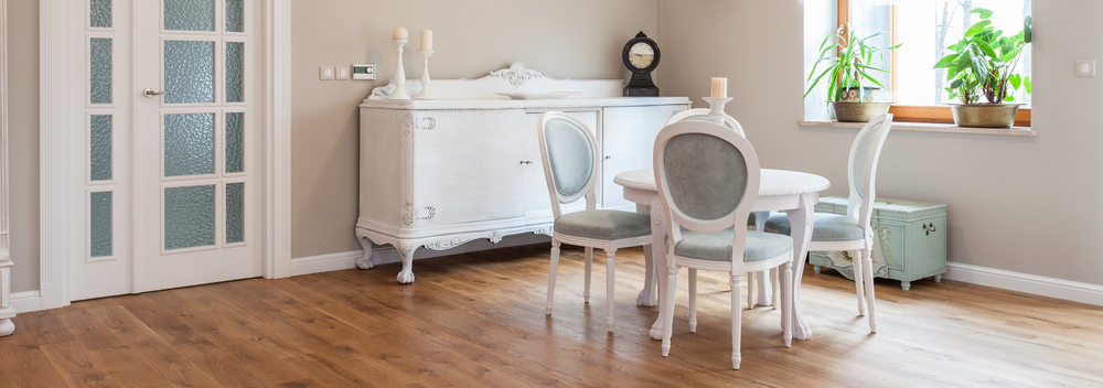 Elegant white wooden table and chairs in dining room