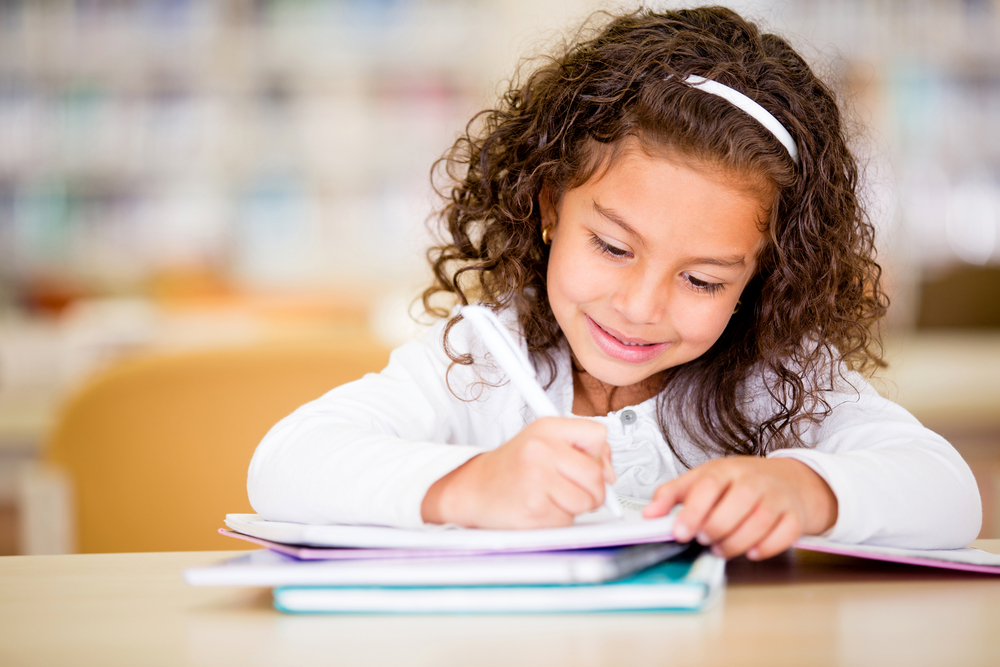 Girl studying at school looking very happy