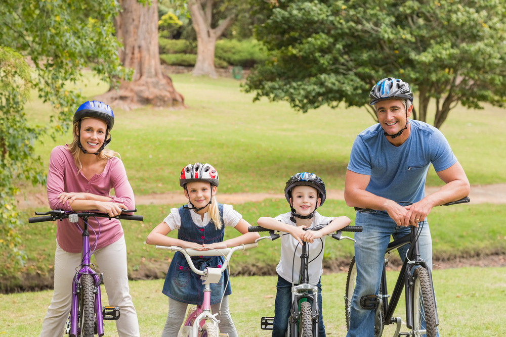 Happy family on their bike at the park on a sunny day