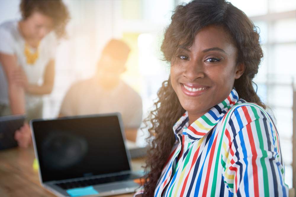 Image of a succesful casual business woman using laptop during meeting-3